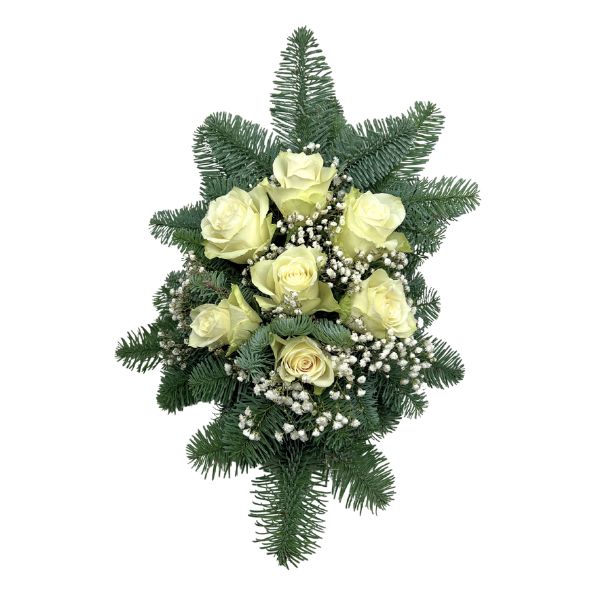 Gravsmyckning med dekorativa blommor och grönska